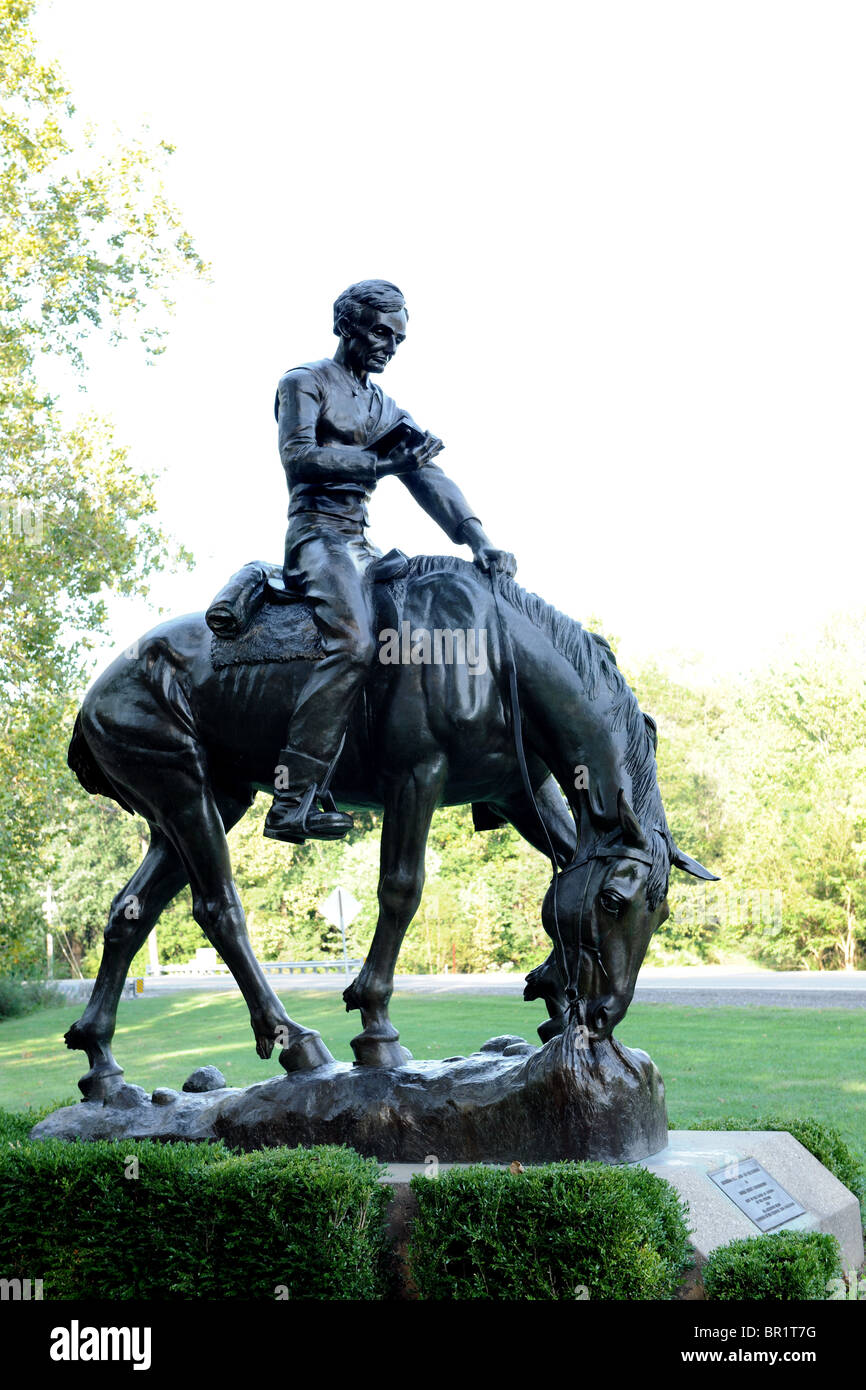 Bronze sculpture of young Abraham Lincoln reading while riding horse in Lincol's New Salem State Historic site Stock Photo