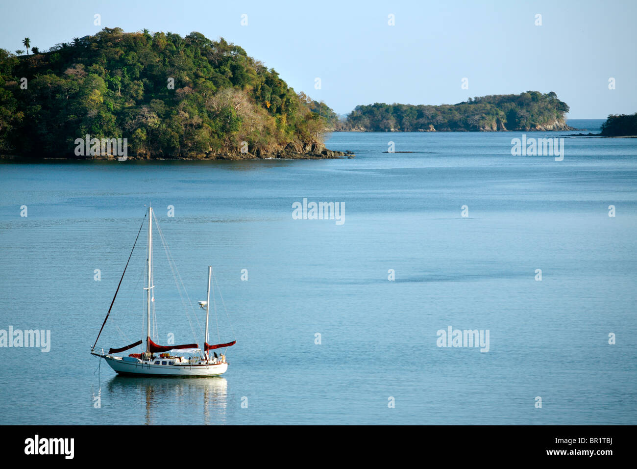 A sailboat floats in a protected bay near Boca Chica, Panama Stock Photo