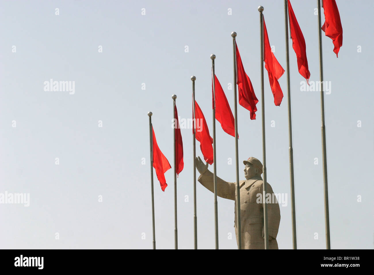 Mao Zedong statue with row of Chinesse flags Stock Photo