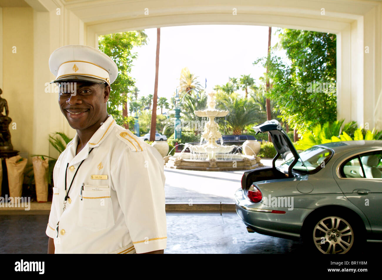 Afro American male hotel valet in uniform with cap Stock Photo