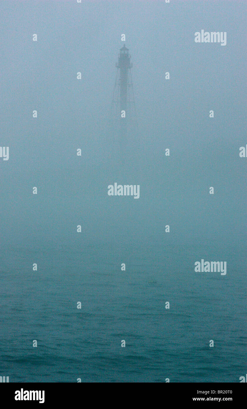 A lighthouse seen through fog. Stock Photo