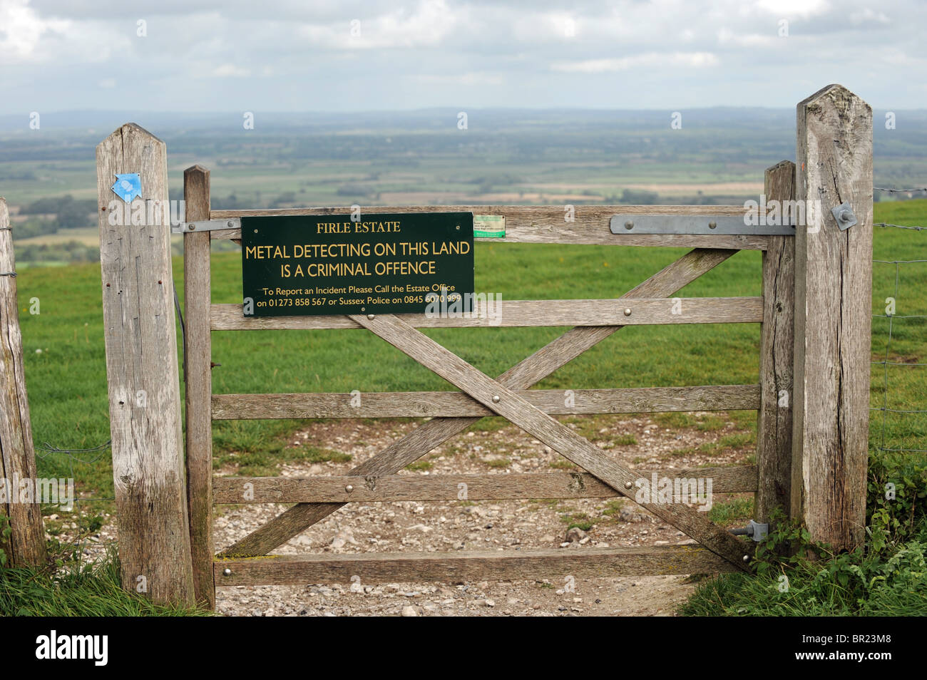 Metal Detecting ban warning sign on a gate on the South Downs Way at Firle near Lewes in East Sussex UK Stock Photo