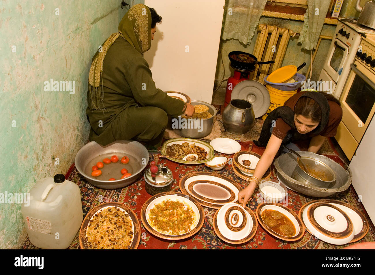 Women prepare an Afghan meal in their kitchen in Kabul. Stock Photo