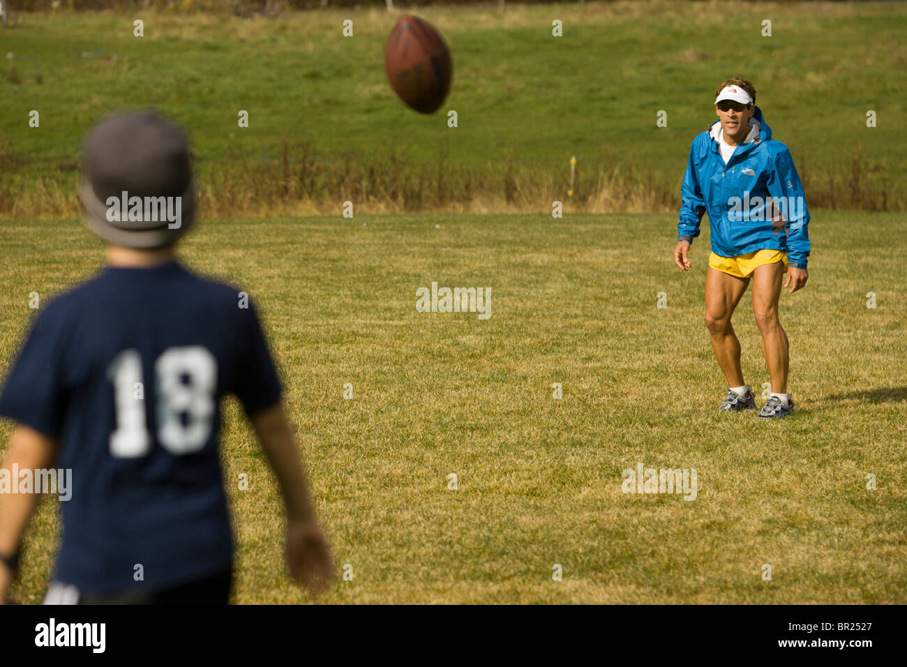 Man throwing a football with his son in Stowe, Vermont Stock Photo Alamy