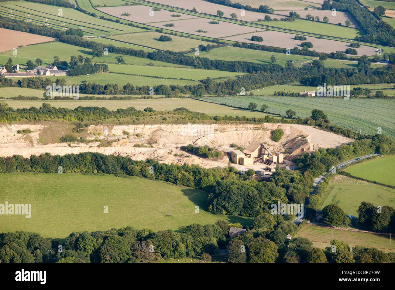 An aerial view of Coscombe Quarry from the west with the Cotswold village of Cutsdean, Gloucestershire visible in the background Stock Photo