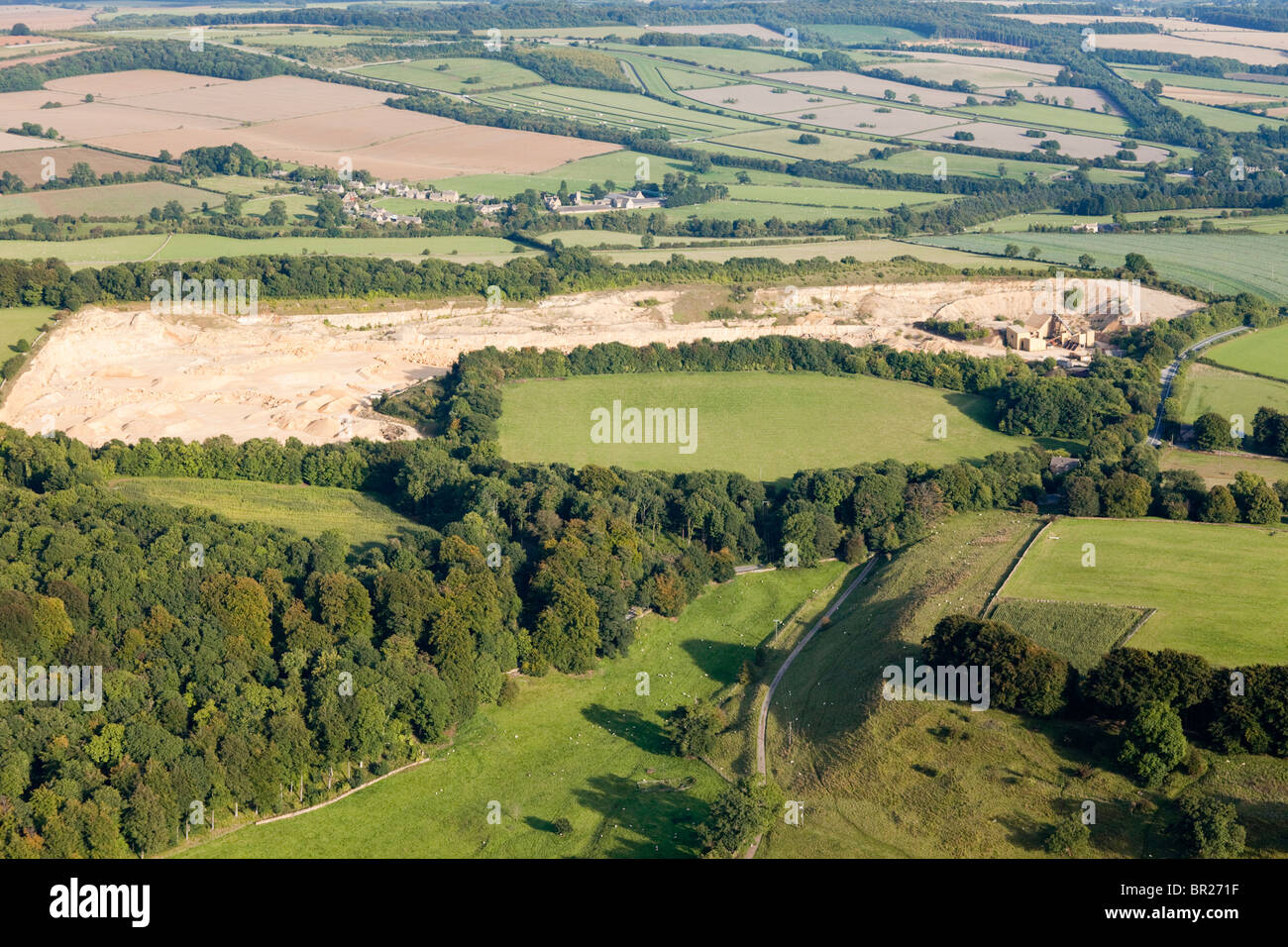 Aerial view of Coscombe Quarry from the west with the Cotswold village of Cutsdean, Gloucestershire visible in the background Stock Photo