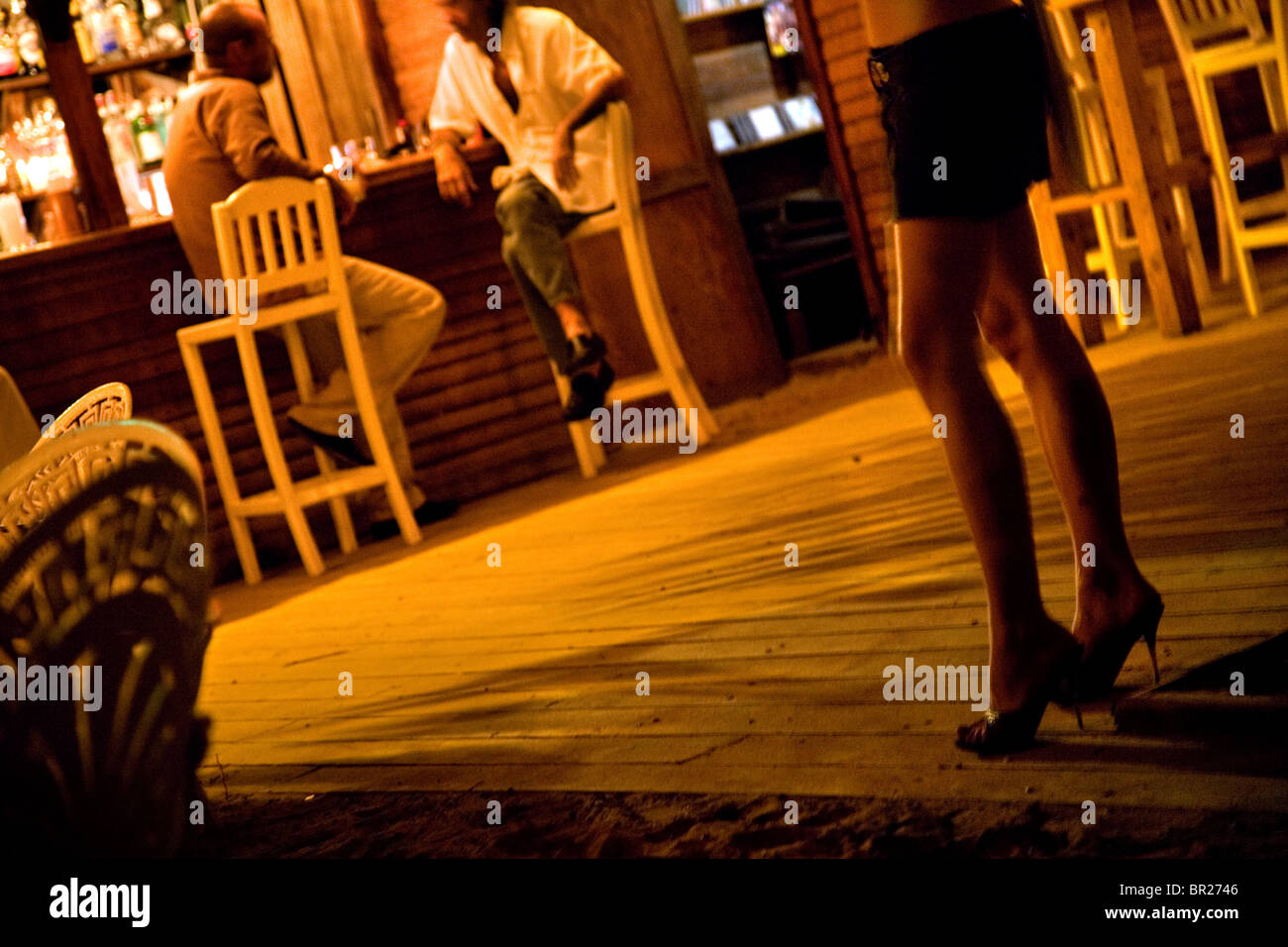 A woman's high heeled legs in a beach bar in the Dominican Republic Stock Photo