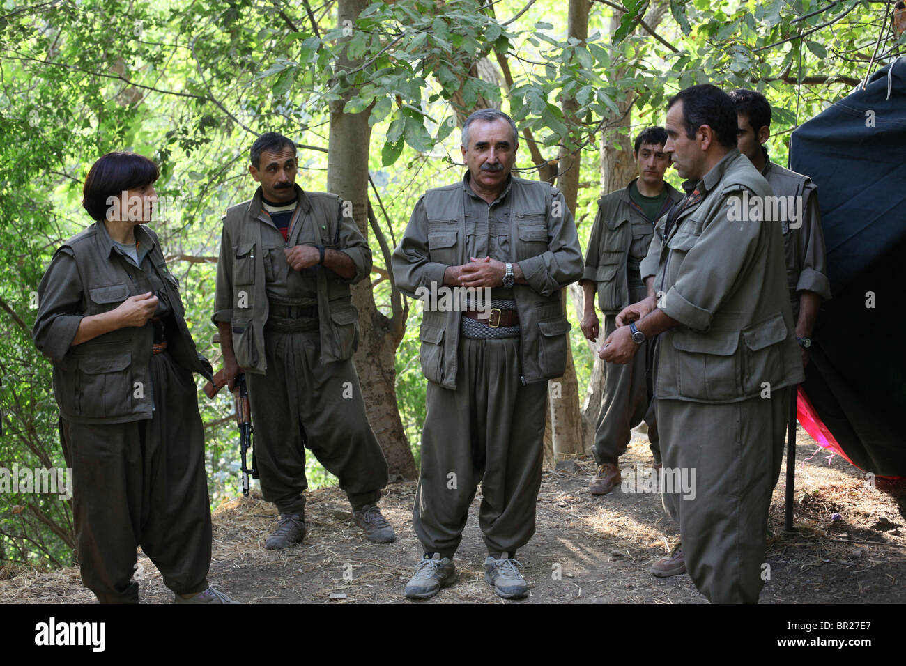Murat Karayilan also nicknamed Cemal the current commander-in-chief of the People's Defence Forces HPG the military wing of the Kurdistan Workers' Party PKK surrounded by his bodyguards and other high rank military commanders in a Kurdish guerilla hideout in a mountainous area in northern Iraq Stock Photo