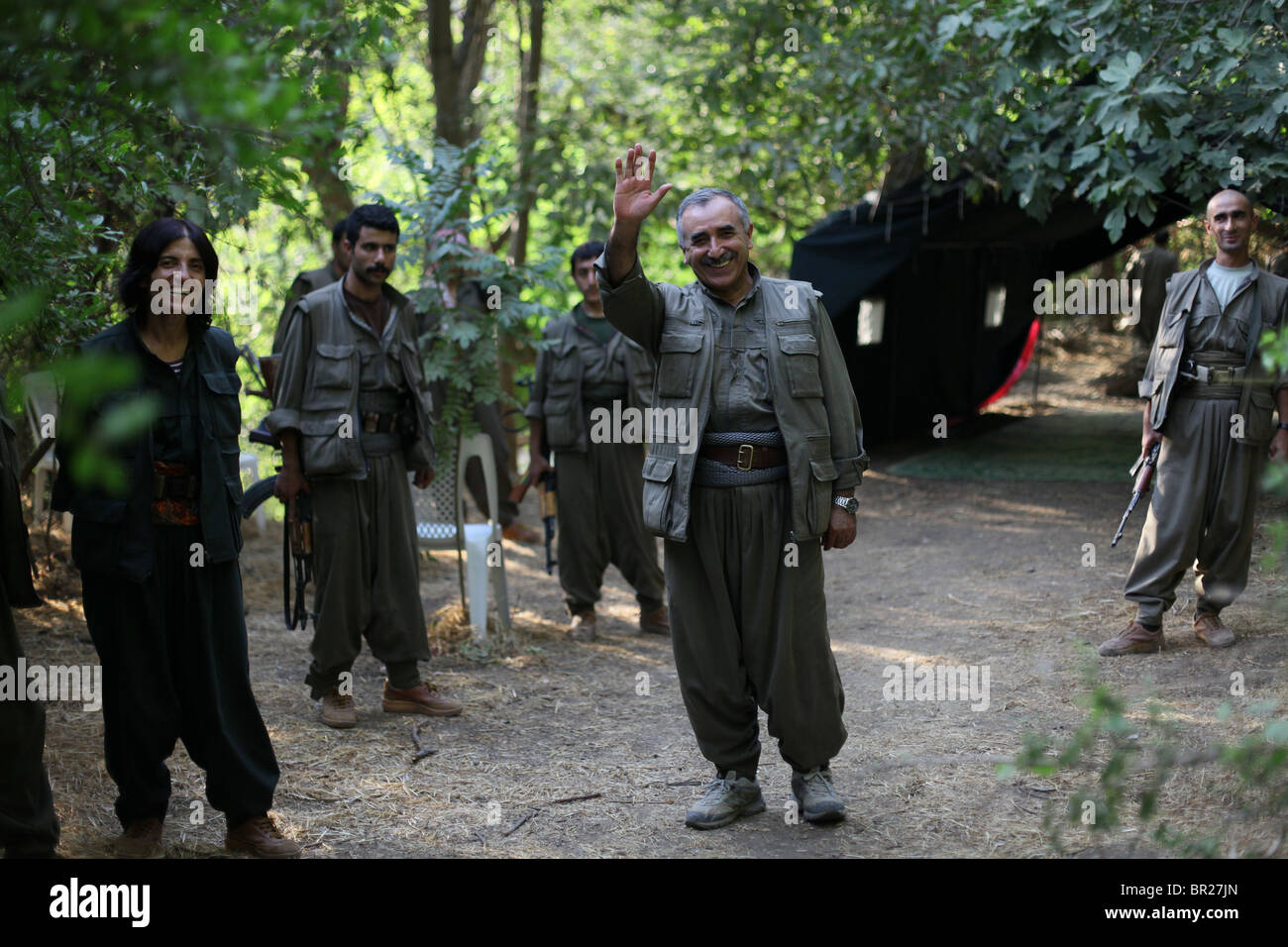 Murat Karayilan also nicknamed Cemal the current commander-in-chief of the People's Defence Forces HPG the military wing of the Kurdistan Workers' Party PKK waves goodbye after an interview in the Kurdish guerilla hideout in a mountainous area in northern Iraq Stock Photo