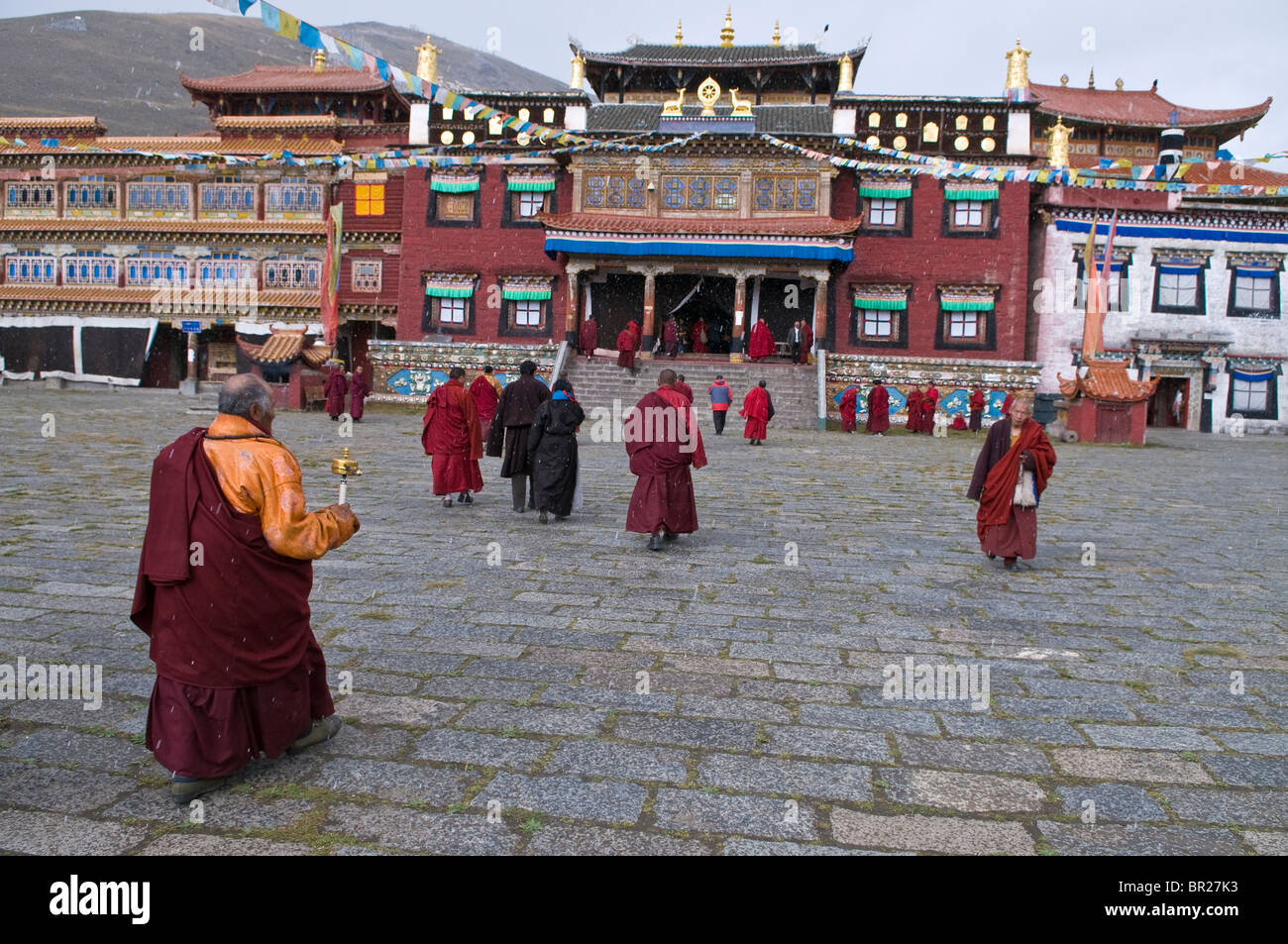 Tibetan Buddhist cross courtyard on way to prayers, Tagong Monastery ...