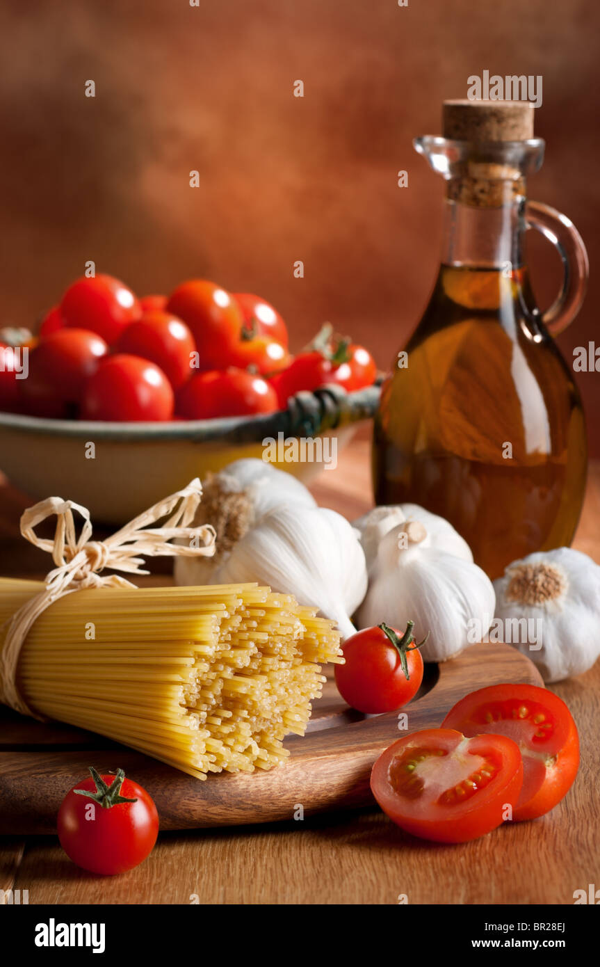 Preparation of spaghetti pasta with tomatoes, garlic and olive oil Stock Photo