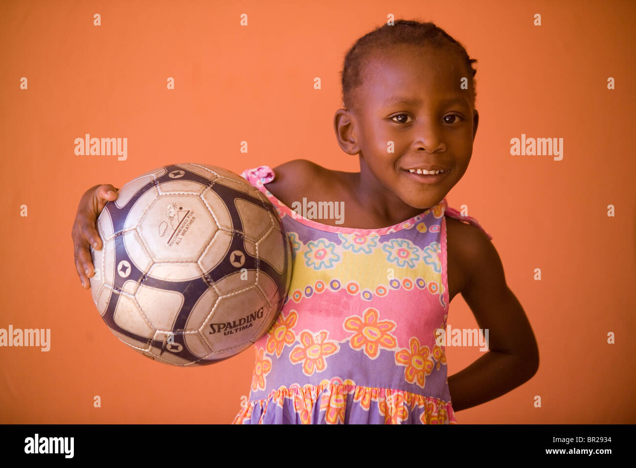 A young girl poses with her new soccer ball she received for her birthday  in Gaborone, Botswana Stock Photo - Alamy