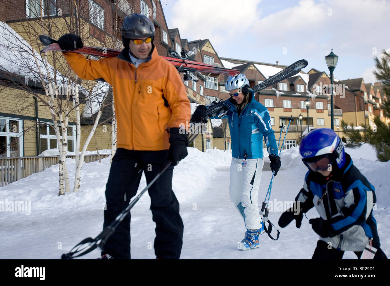 A family walks with skis at a resort in Newry, Maine. Stock Photo