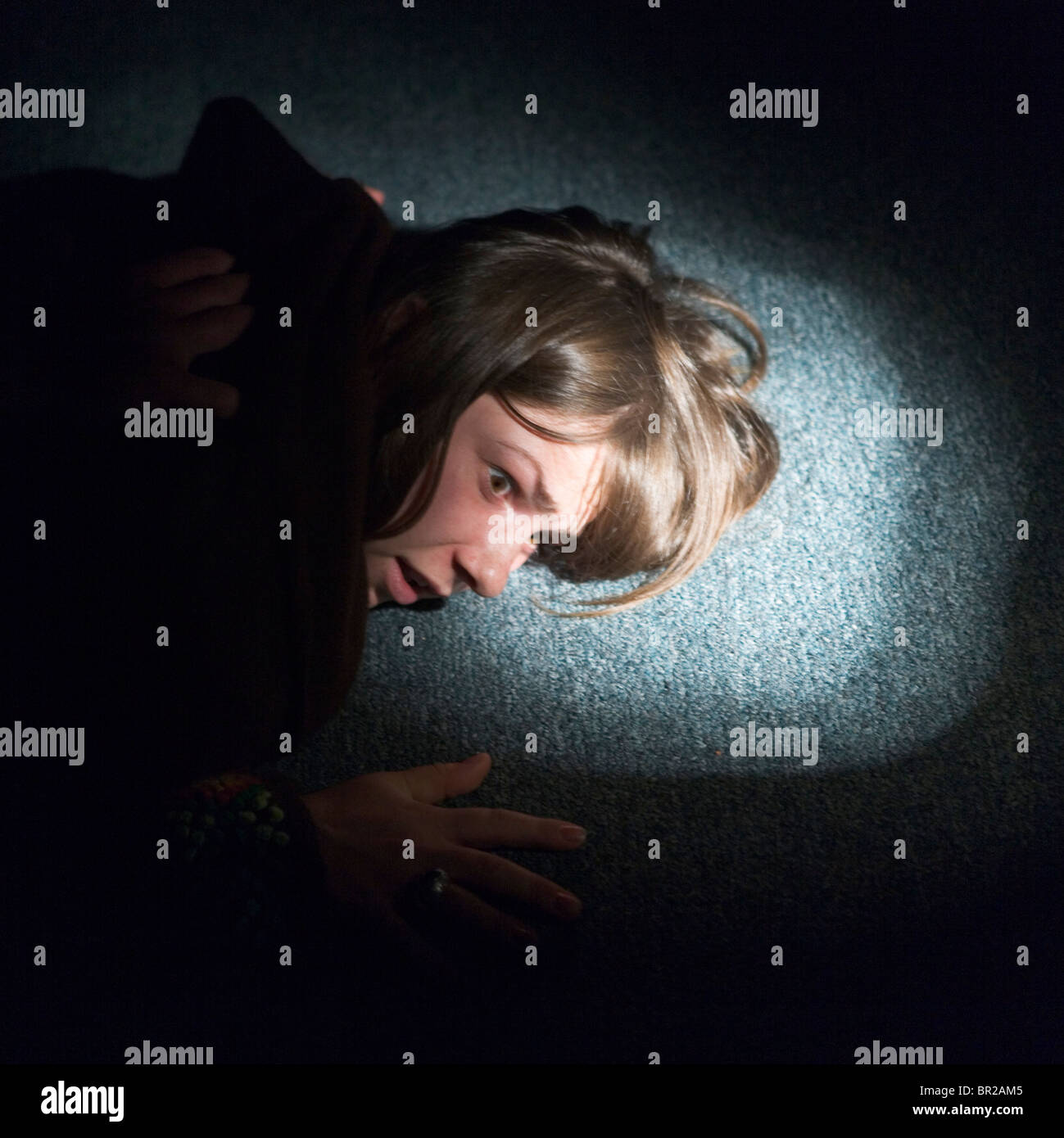 A woman with her face against the floor. Stock Photo