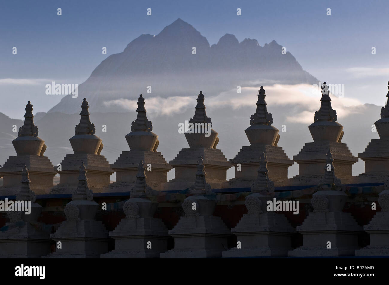 Yala Mountain's snow covered peak rises above Tagong Temple stupas, Sichuan Province, China Stock Photo