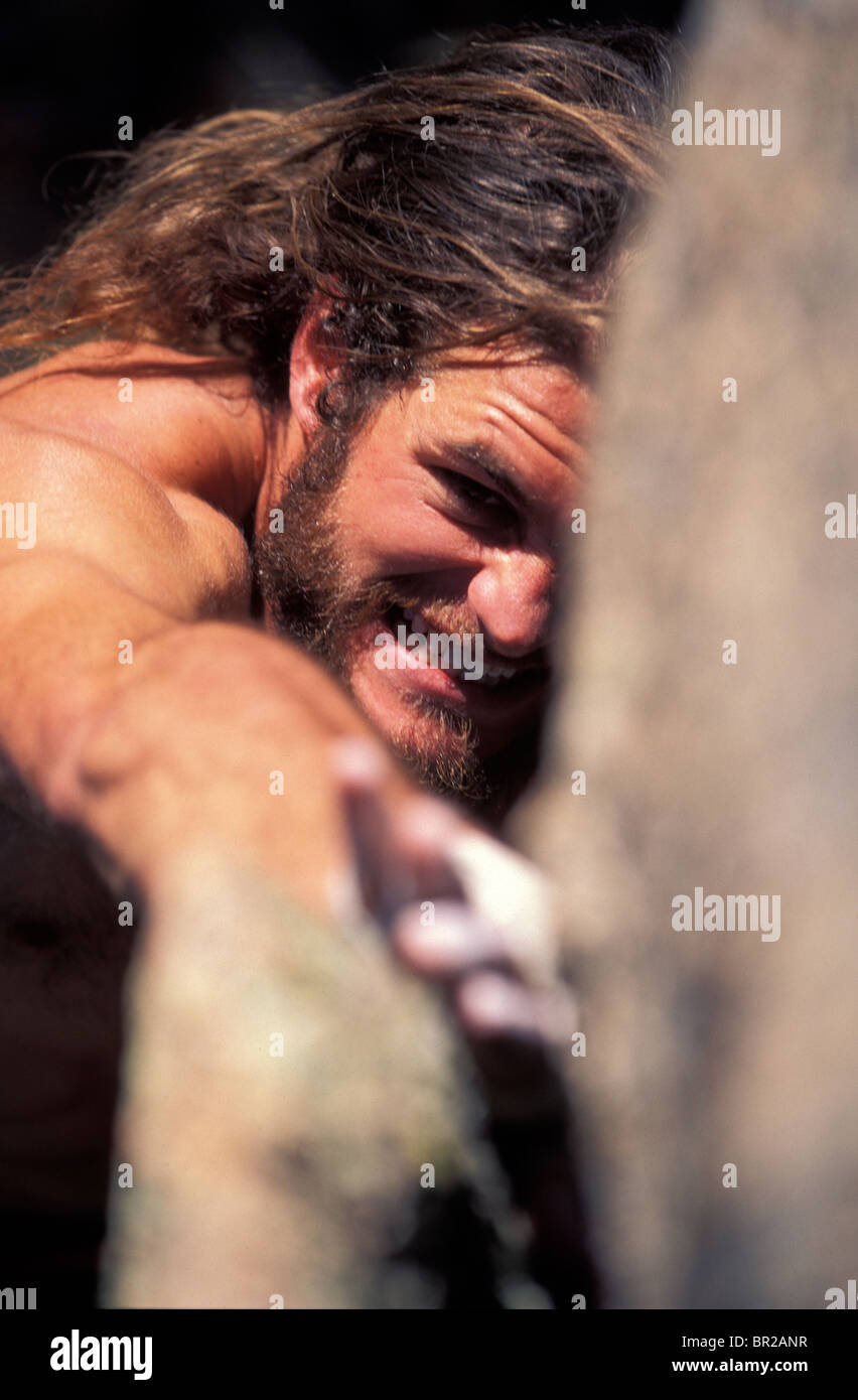 Man Bouldering And Grimacing While Reaching For A Hold Stock Photo Alamy