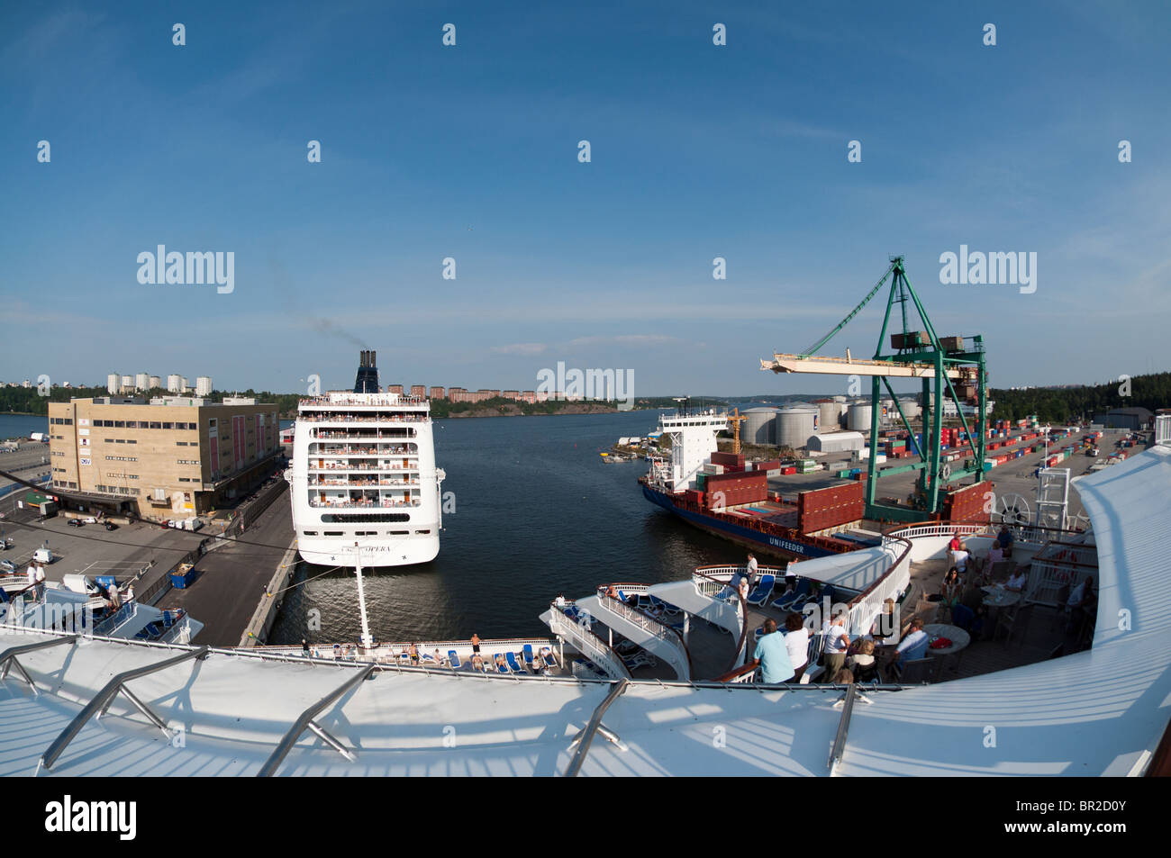 A fisheye photograph of the aft/stern of the P&O cruise ship 'Aurora', the MSC cruise ship 'Opera' and a container ship. Stock Photo