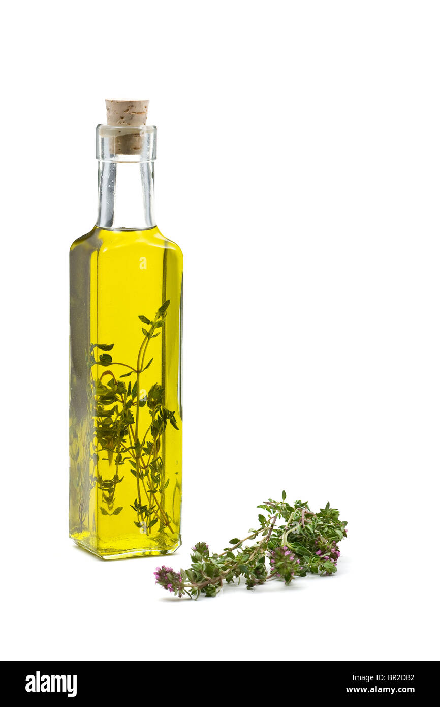 Thyme infused olive oil over white background Stock Photo