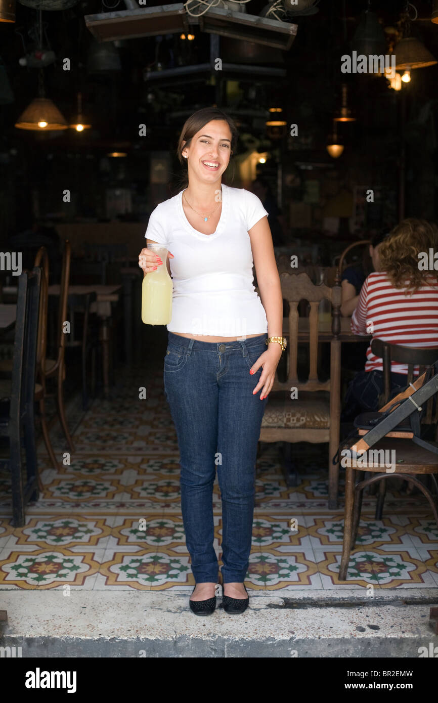 A waitress holds a carafe of lemonade at Dr. Shakshouka, a kosher Tripolitanian restaurant in Jaffa, Tel Aviv, Israel Stock Photo