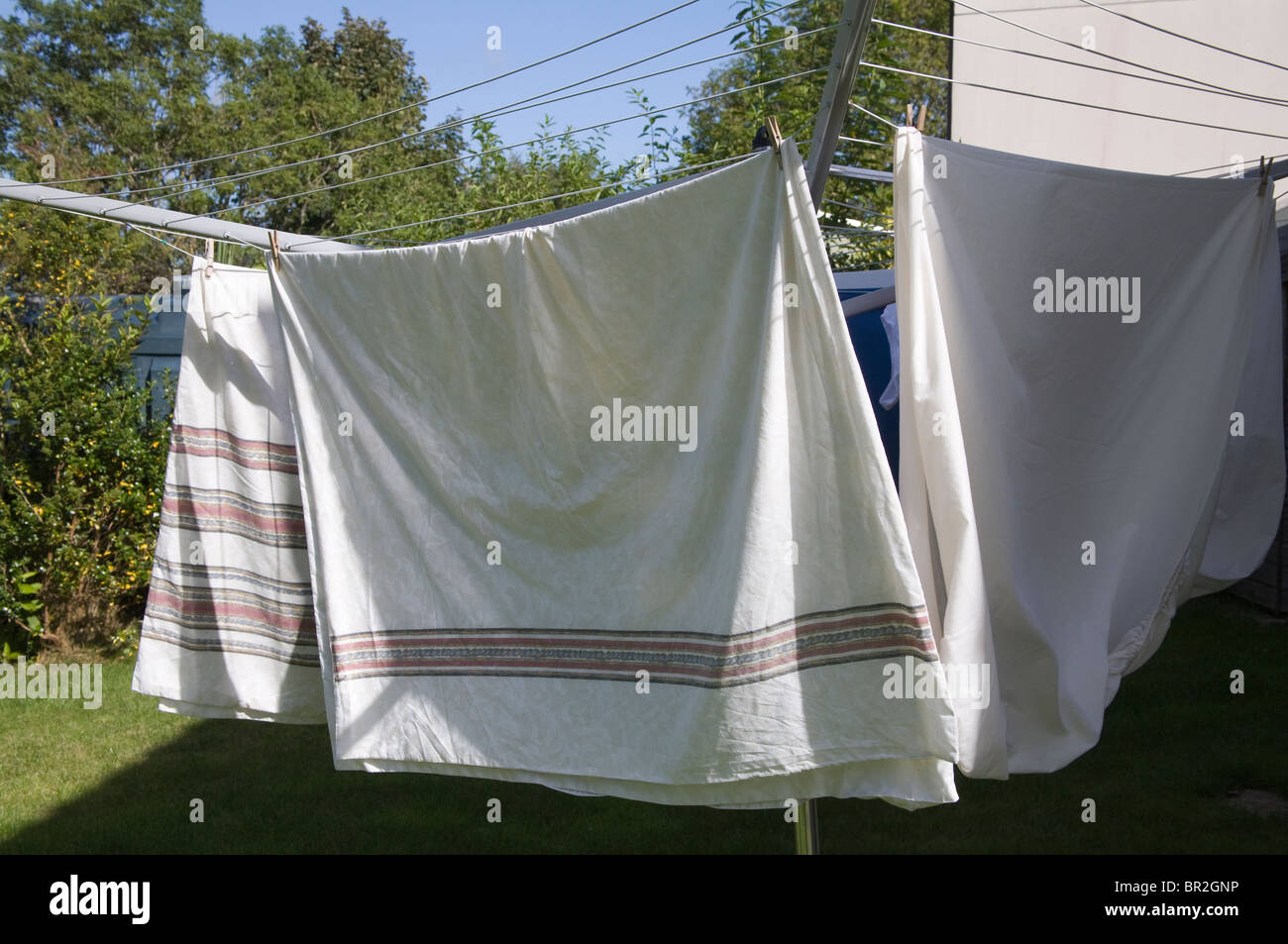 Close up of bedding on a rotary washing line drying naturally in the sunshine Stock Photo