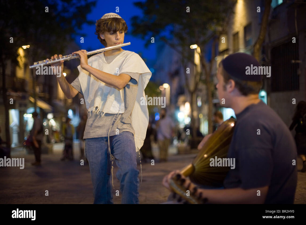 Boys dressed in traditional Israeli and Jewish clothes play the flute and mandolin on Ben Yahuda Street, Jerusalem, Israel Stock Photo