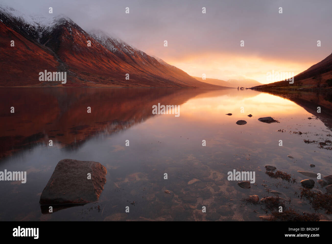 Blazing light from a winter sunset lights up Loch Etive in the Highlands of Scotland Stock Photo