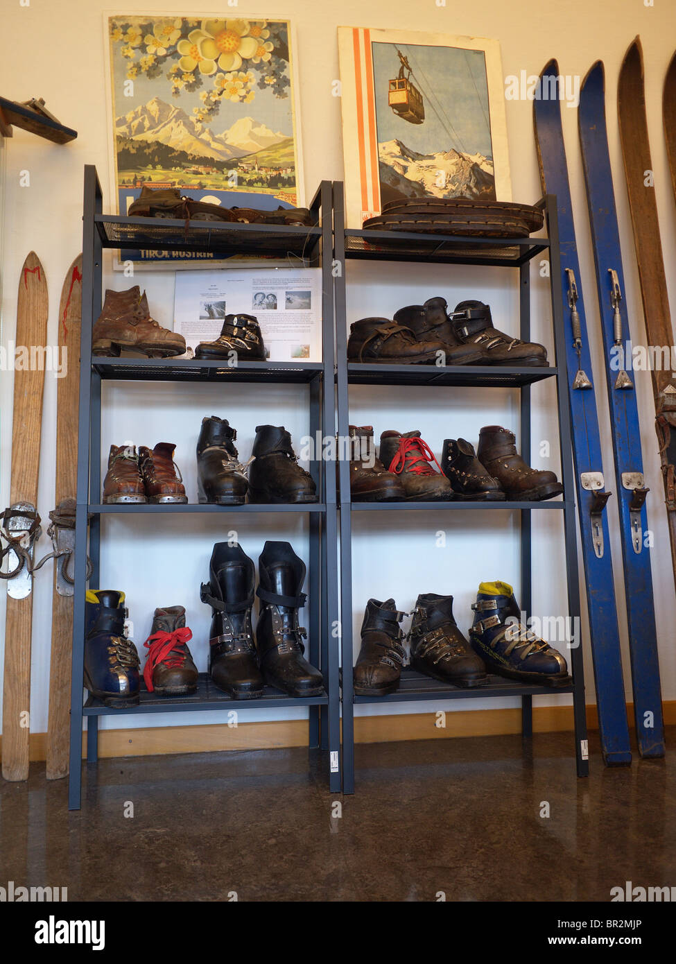 Display of old fashioned skis and boots at the museum in the Ski resort of Igls near Innsbruck Austria Stock Photo