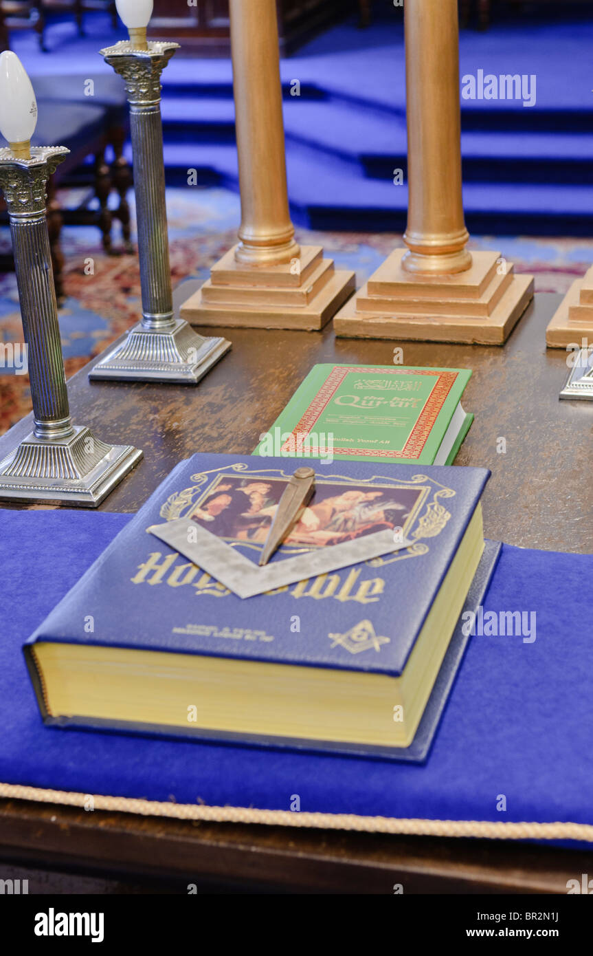 The Holy Bible, and The Holy Qu'Ran on a table in a Masonic Lodge Stock