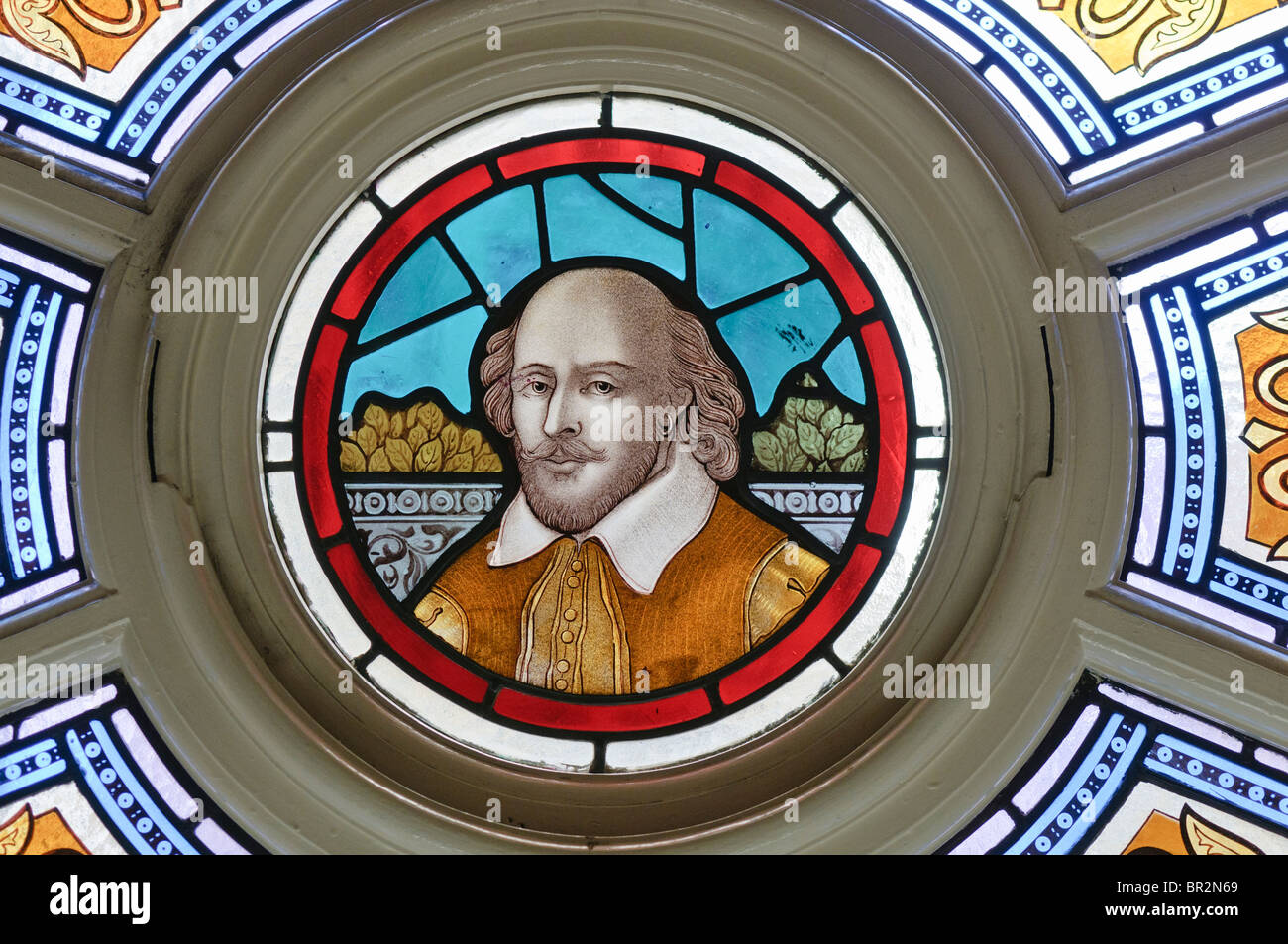 Stained Glass window with William Shakespeare in the centre Stock Photo