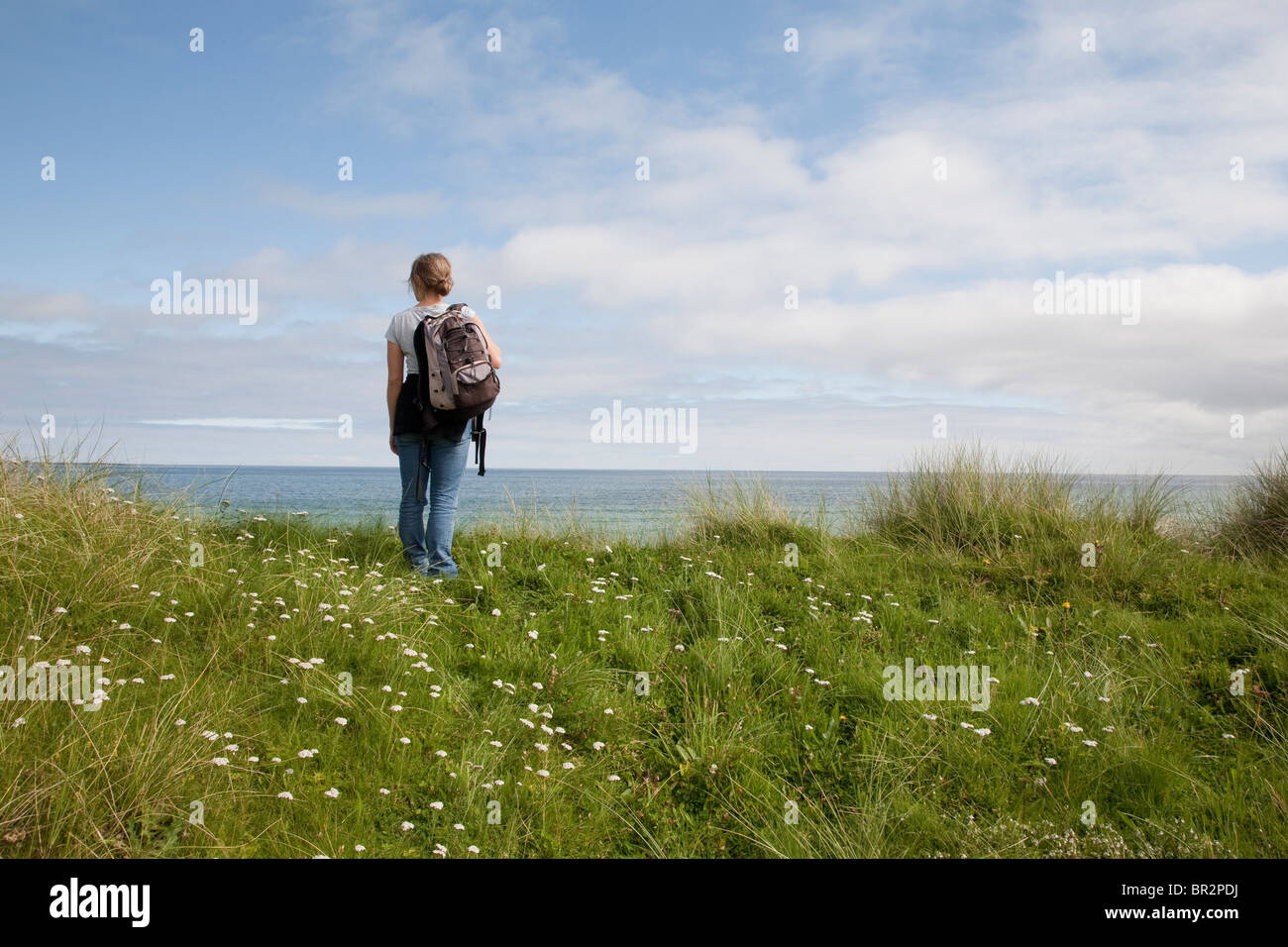 Female Treker on the Isle of Sanday, Orkney Islands, Scotland Stock Photo