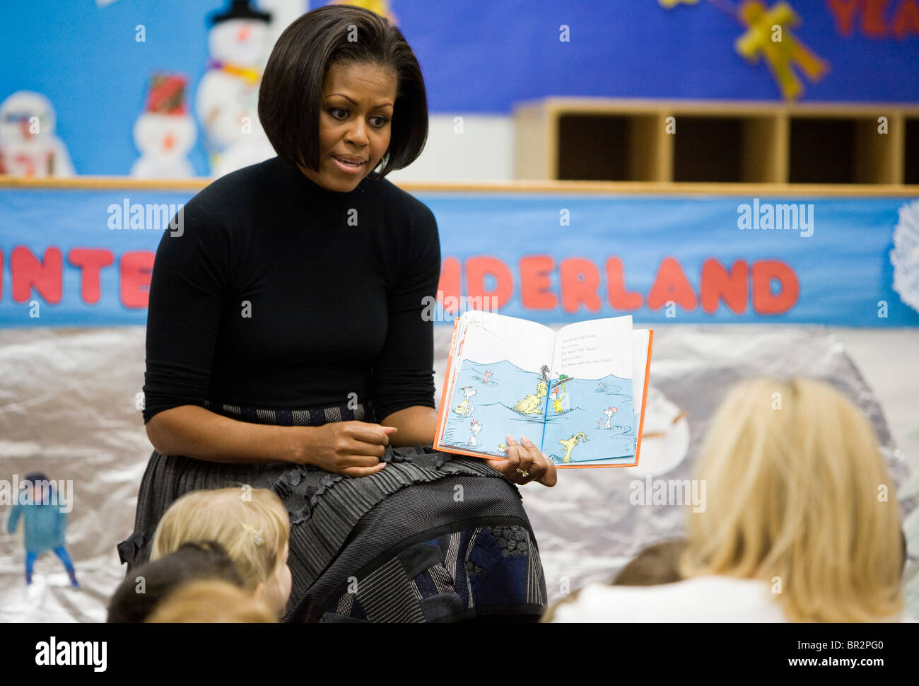First Lady Michelle Obama reads to children at the Dept. of Labor daycare center. Stock Photo