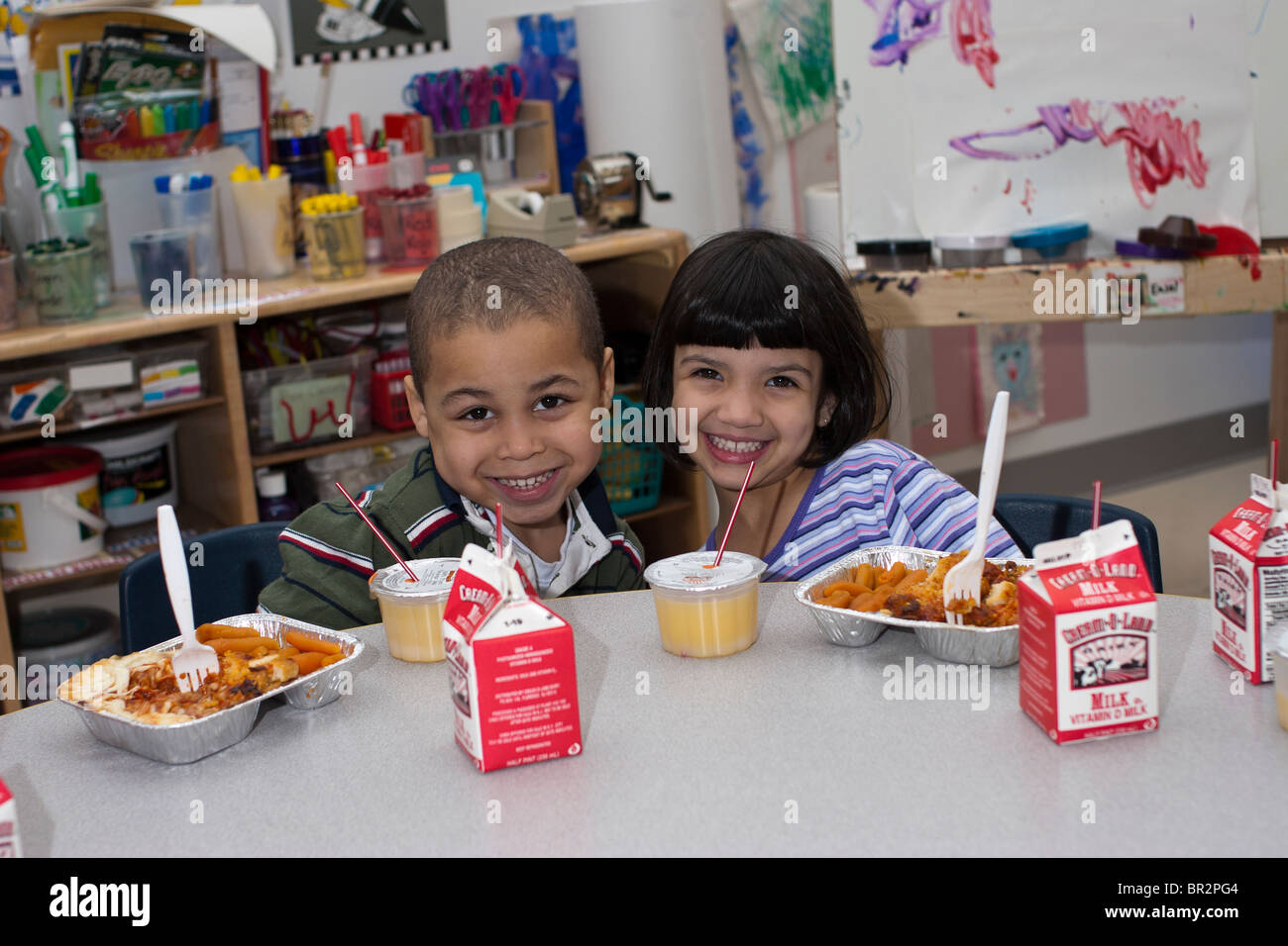4 year old preschool children eating lunch in the classroom Stock Photo