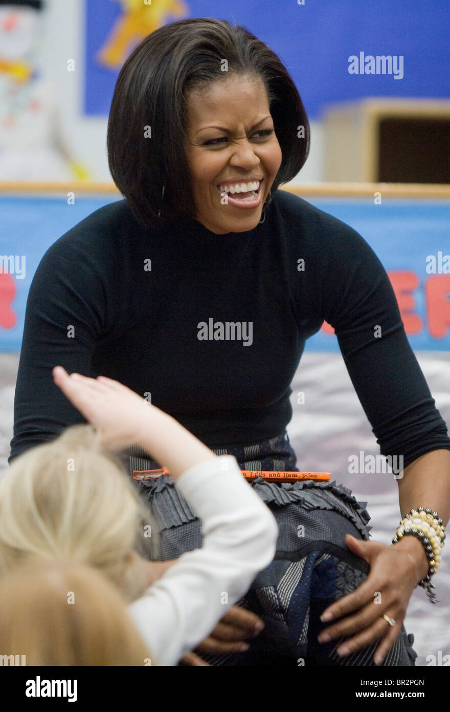 First Lady Michelle Obama reads to children at the Dept. of Labor daycare center. Stock Photo
