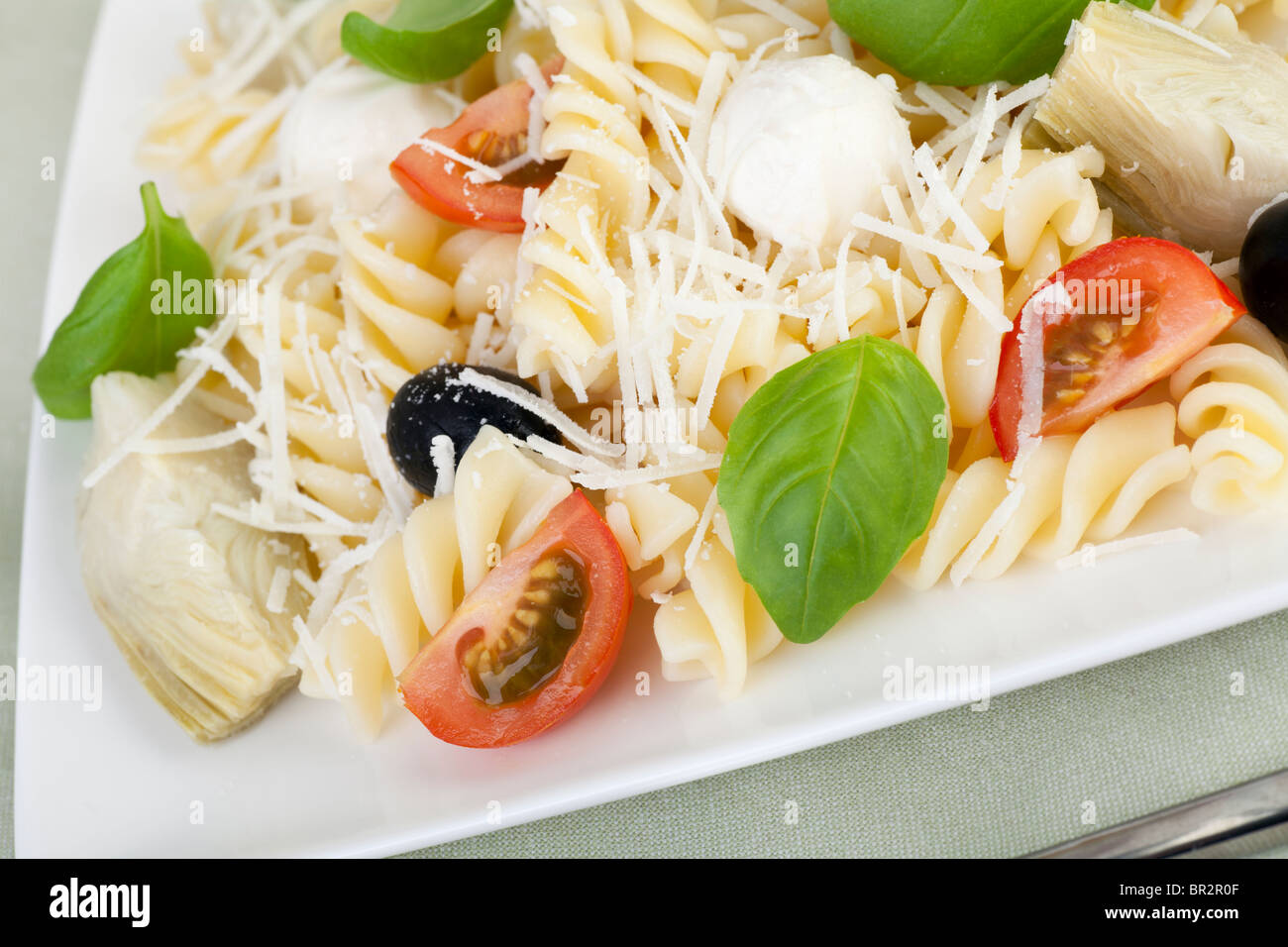 Fusilli pasta with black olives, mozzarella cheese, artichoke hearts