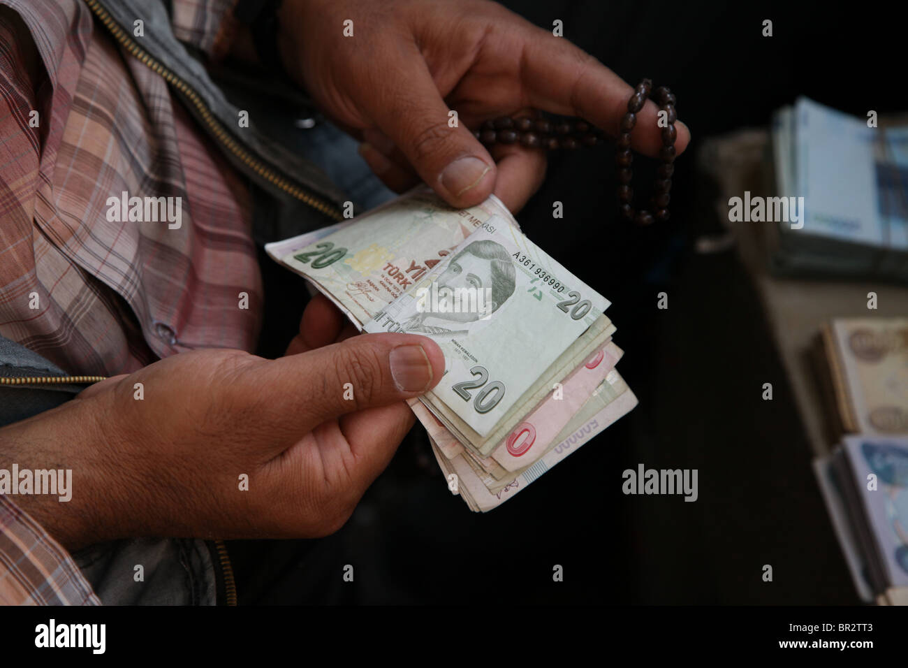A vendor counting Turkish Lira banknotes in the market Turkey Stock Photo