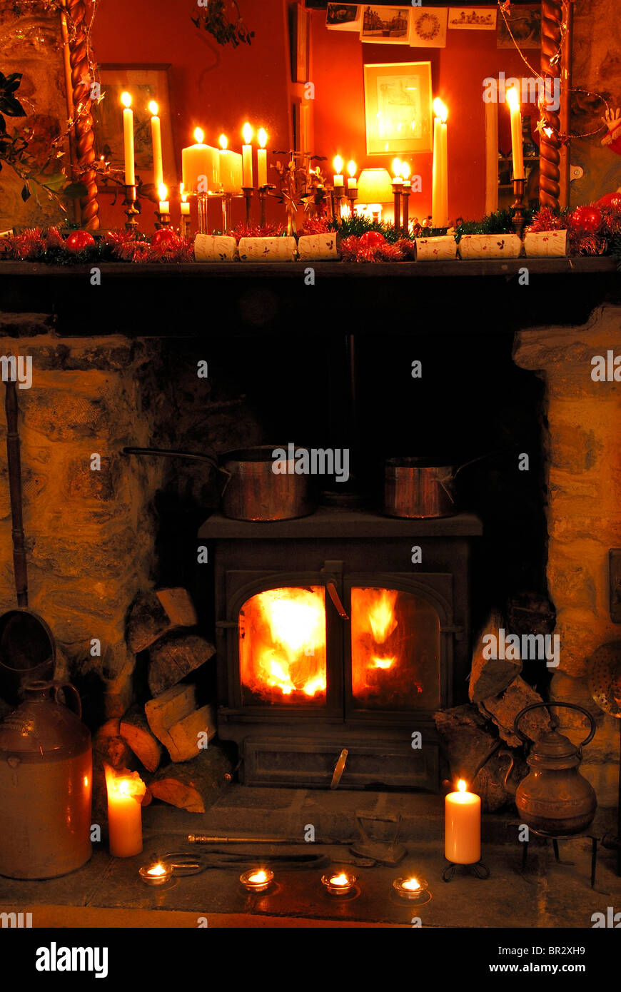 A Muti Fuel Stove Burning Logs At Christmas Time With Candles