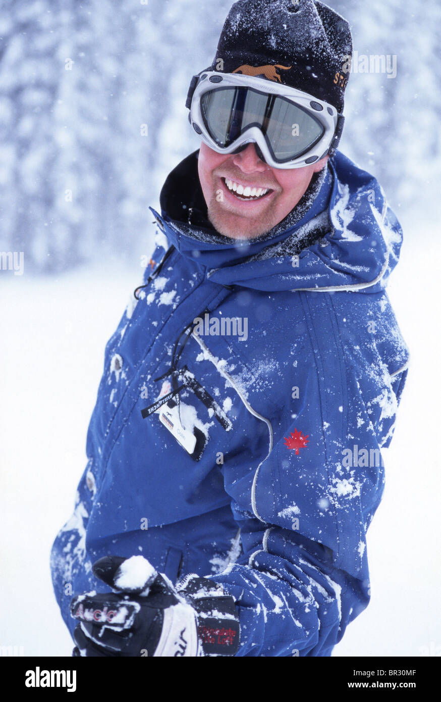 Ski instructor covered in snow smiling at camera Stock Photo Alamy