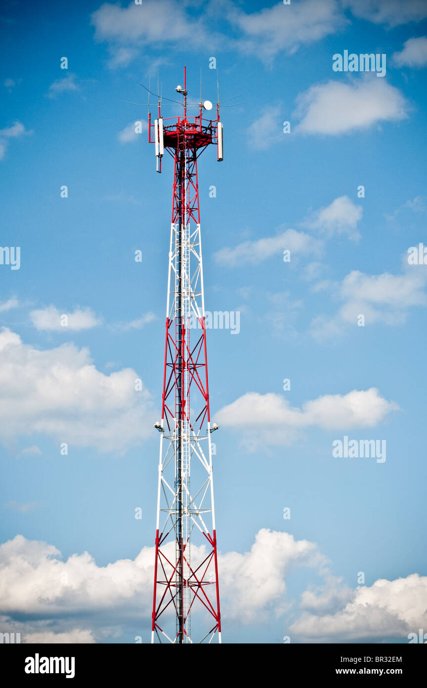 Telecommunication tower on blue cloudy sky Stock Photo