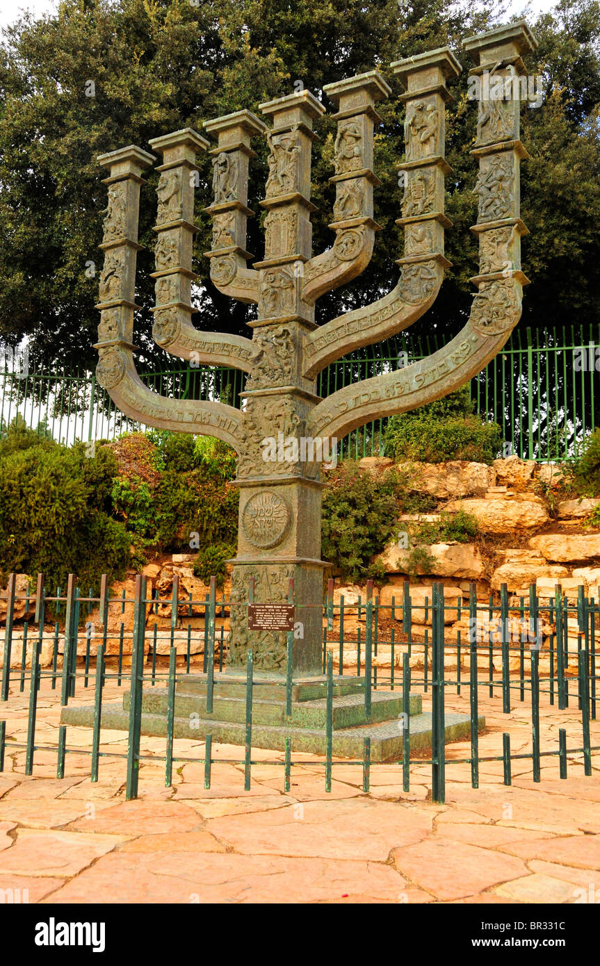 Menorah, seven branched candelabrum which for Jews symbolizes Enlightenment, Israeli government building at back, Knesset Stock Photo