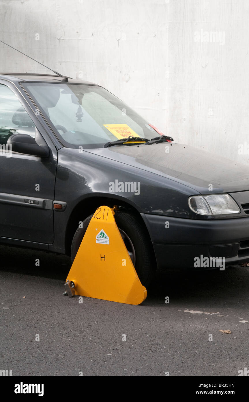 Illegal, untaxed and wheel clamped car in public street Stock Photo Alamy