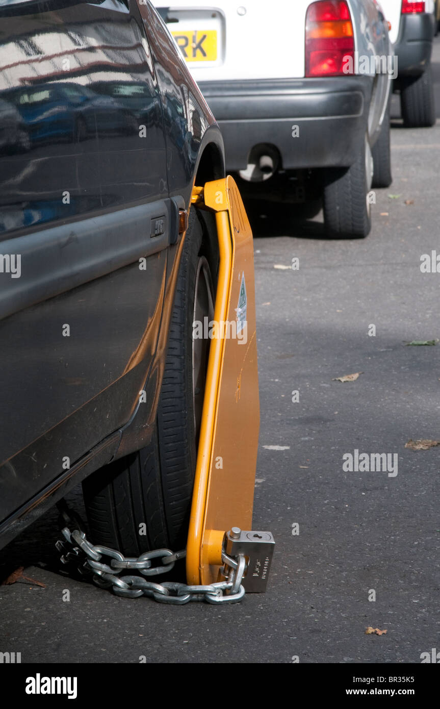Illegal, untaxed and wheel clamped car in public street Stock Photo Alamy