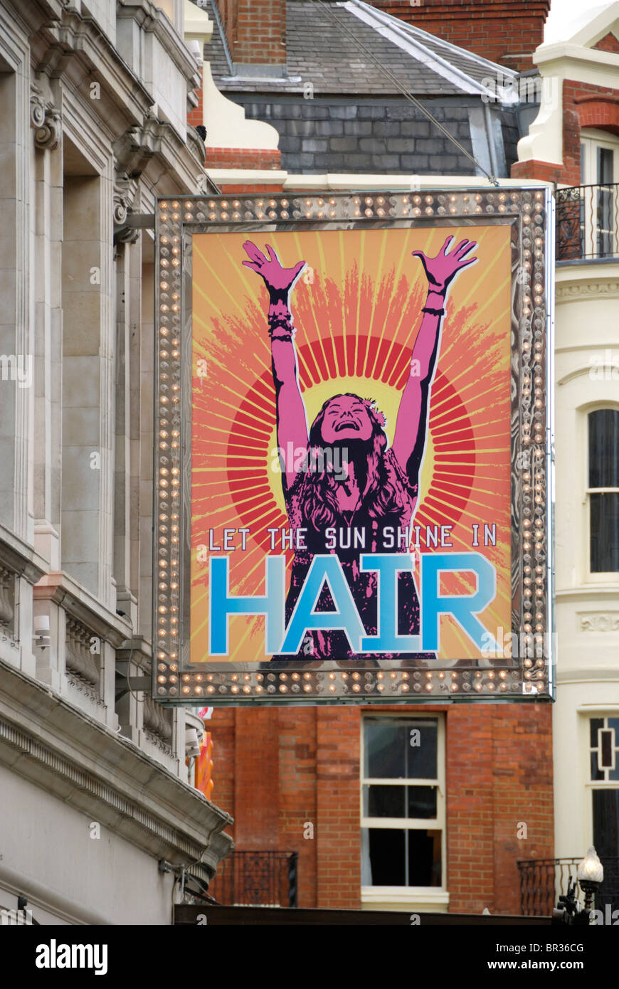 A large billboard promoting the musical 'Hair' outside the Gielgud Theatre, Shaftesbury Avenue, London, England Stock Photo