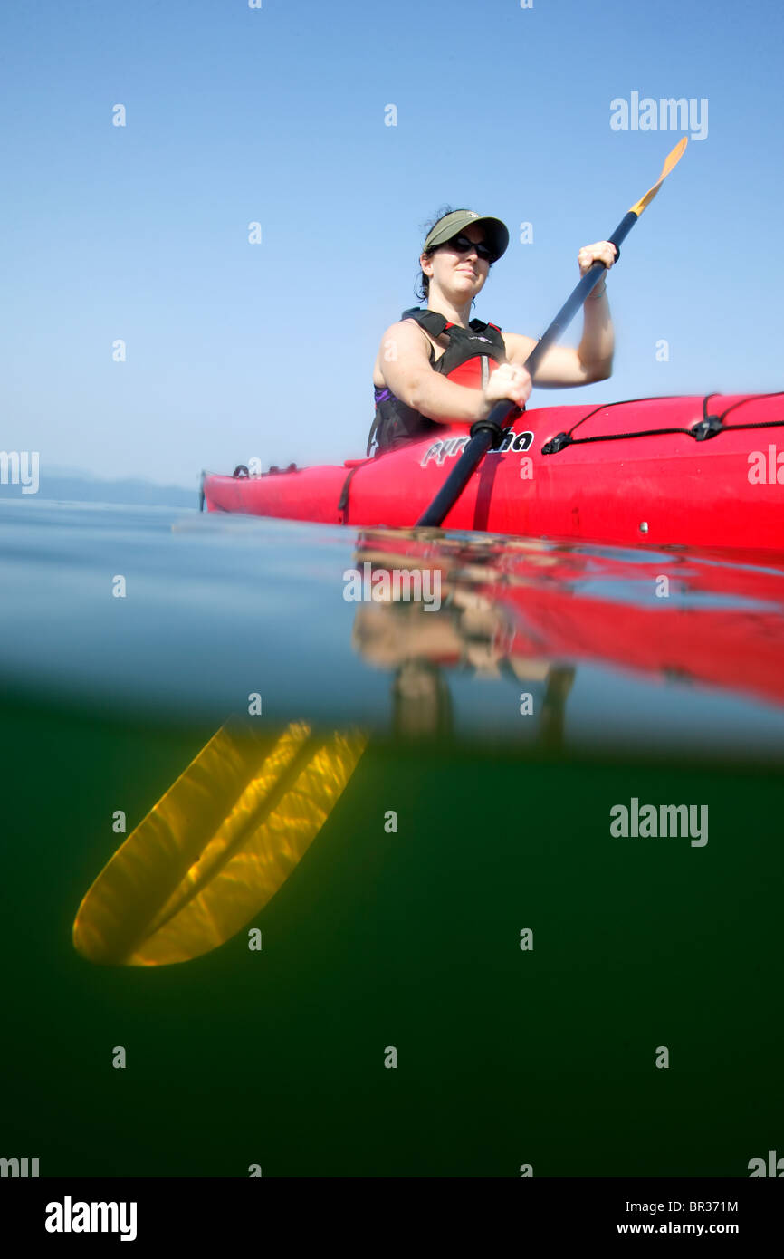 Halfunderwater shot of female sea kayaker on Lake Jocassee along the