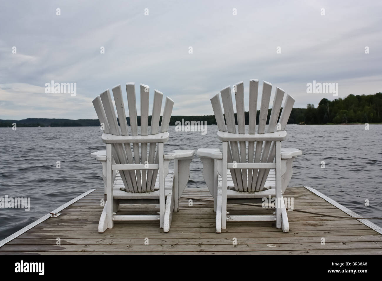 white wooden lawn chair outdoor lake deck cloudy Stock Photo Alamy