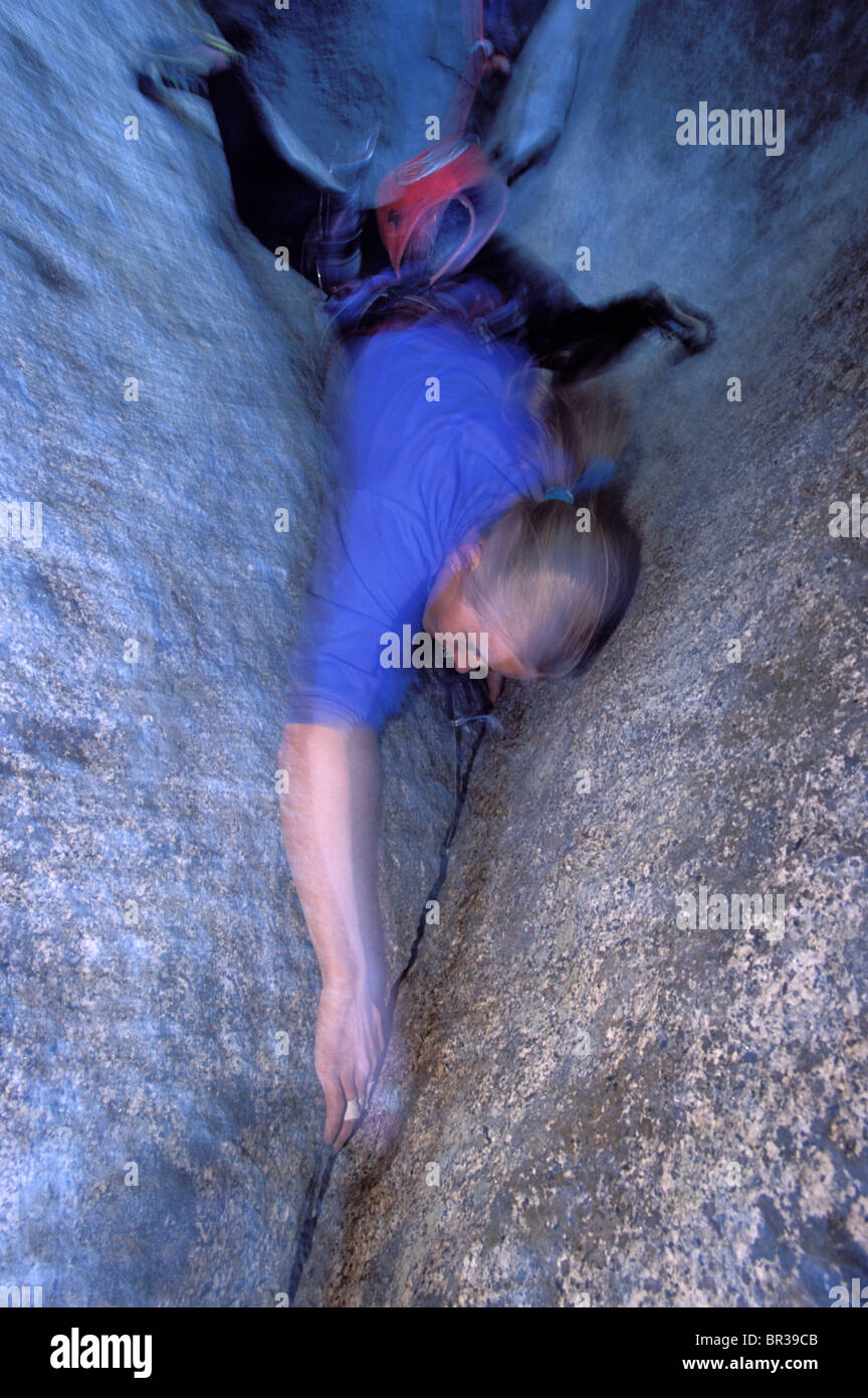 Female climber leading a crack climb (high angle perspective Stock