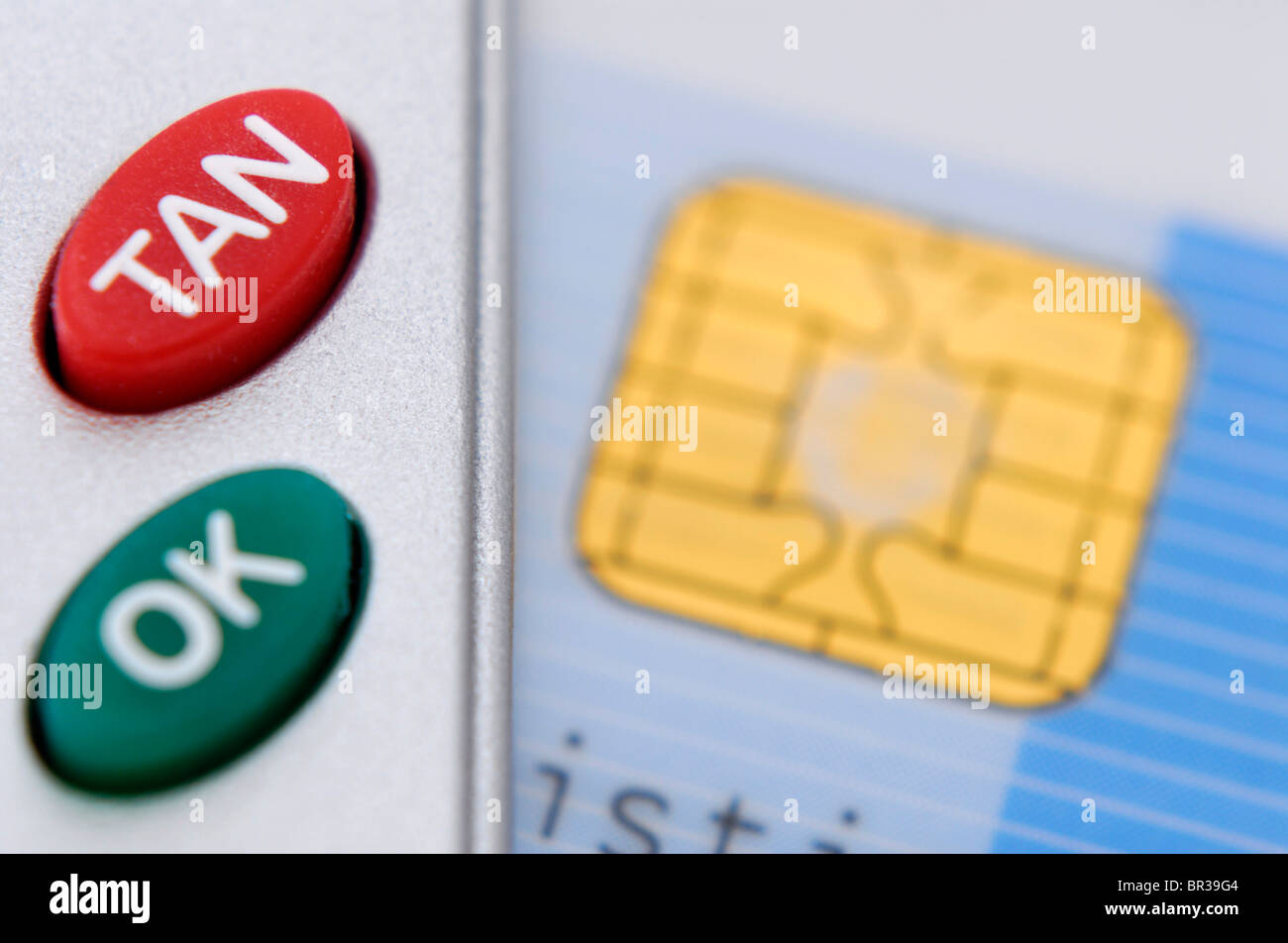 TAN-button on a card reader and a cash card, online banking Stock Photo