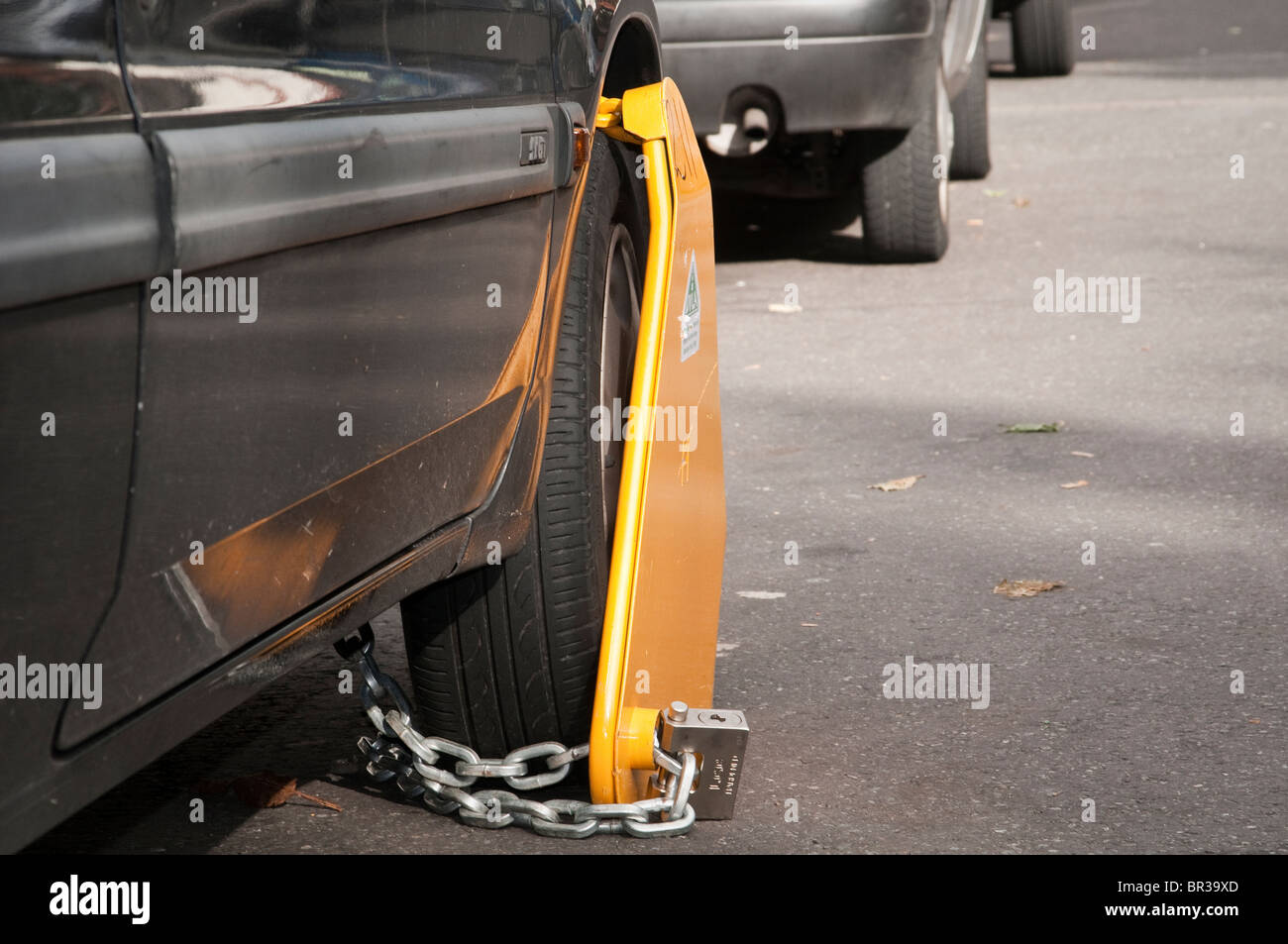 Illegal, untaxed and wheel clamped car in public street Stock Photo Alamy