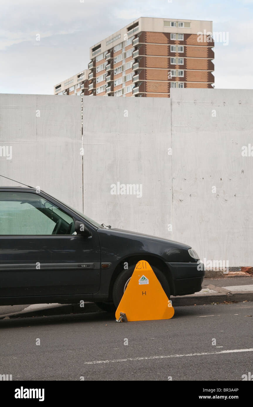 Illegal, untaxed and wheel clamped car in public street Stock Photo Alamy