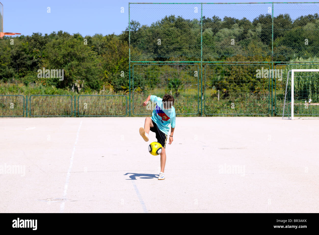 Teenage Boy playing soccer / football Stock Photo