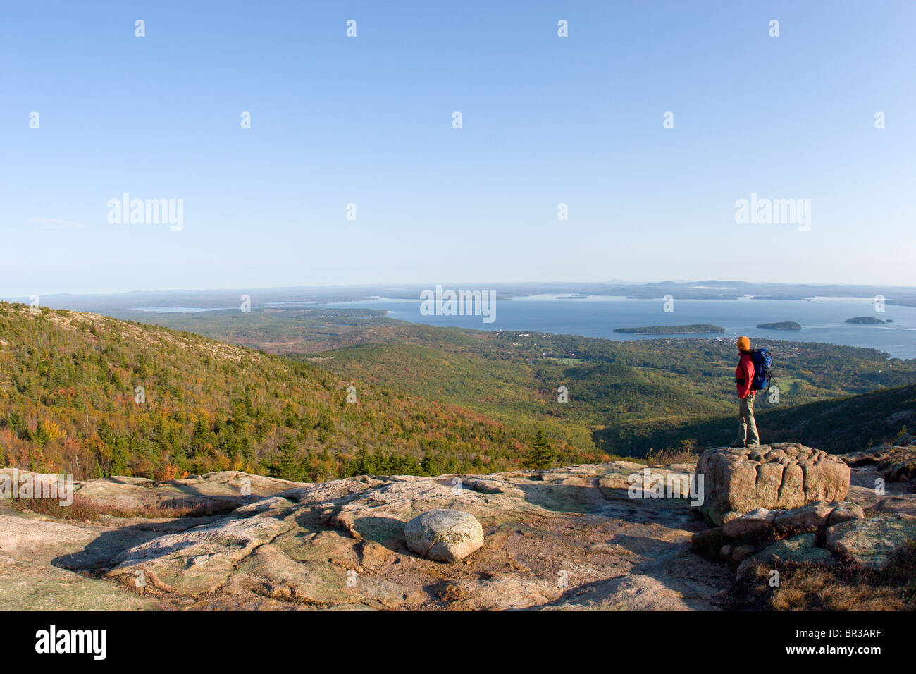 Young woman hiking on Cadillac Mountain in Acadia National Park. Bar